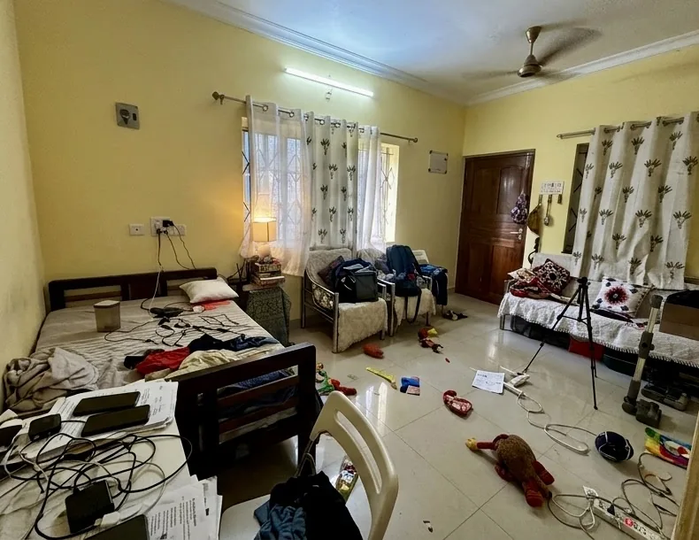 A cluttered, hard-lit corner of a home